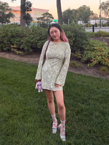 A front view of Allure commerce editor Sarah Han wearing the Sticky Cakes Lift underneath a green dress